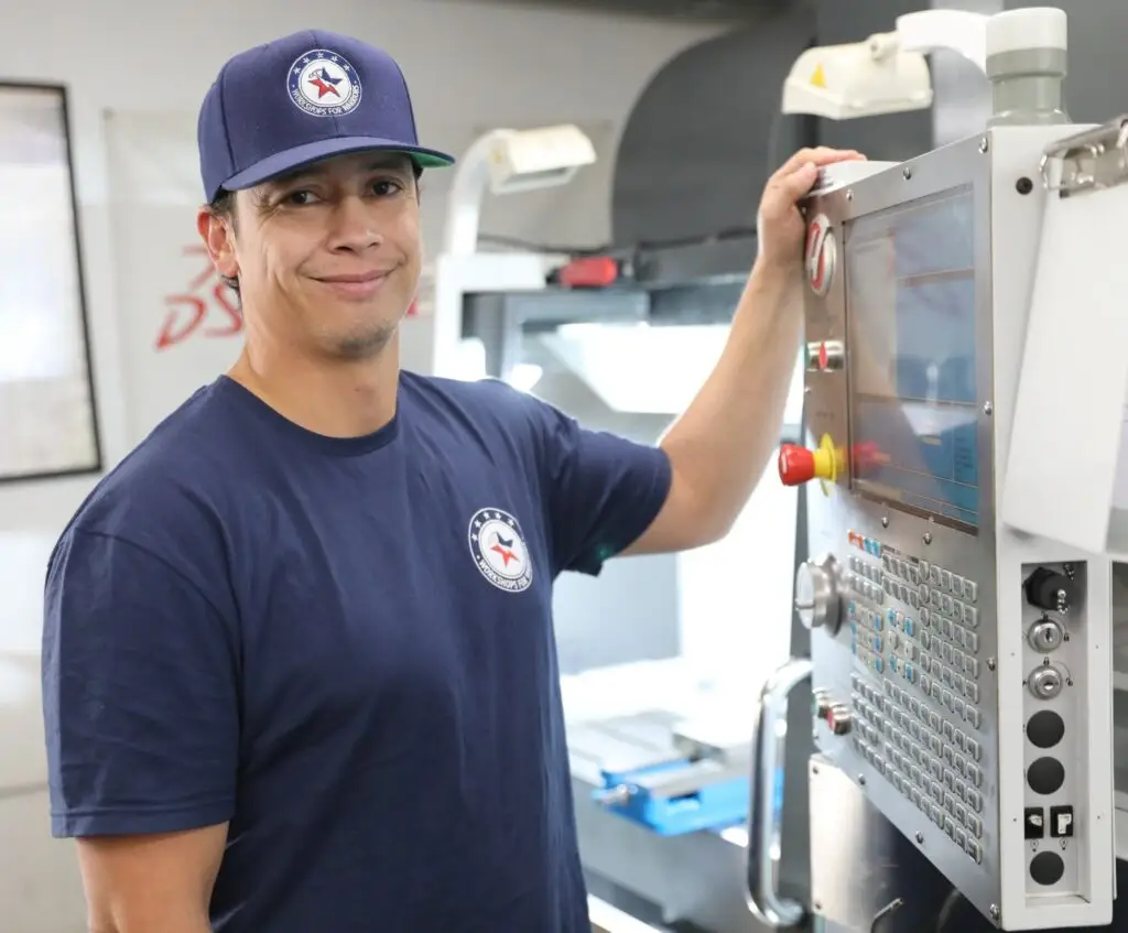 Smiling male machining student at Workshops For Warriors