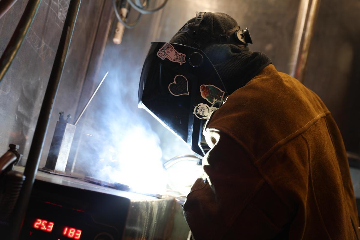 Female welder at Workshops for Warriors embedded in blog post Margarita's journey from Marine to welder